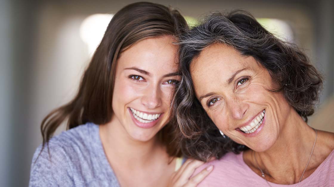 Mother and daughter smiling